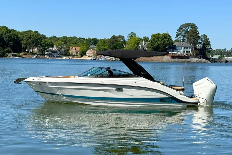 Slide: The Image of 2026 Sea Ray SLX 260 Outboard on a serene lake. - 0