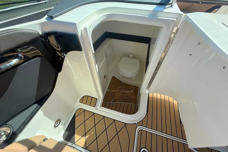 Slide: The Image of Interior of 2026 Sea Ray SLX 260 Outboard featuring a toilet. - 18