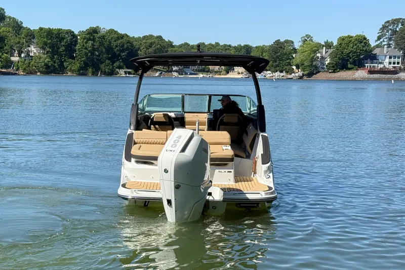Slide: The Image of 2026 Sea Ray SLX 260 Outboard on a tranquil lake. - 2