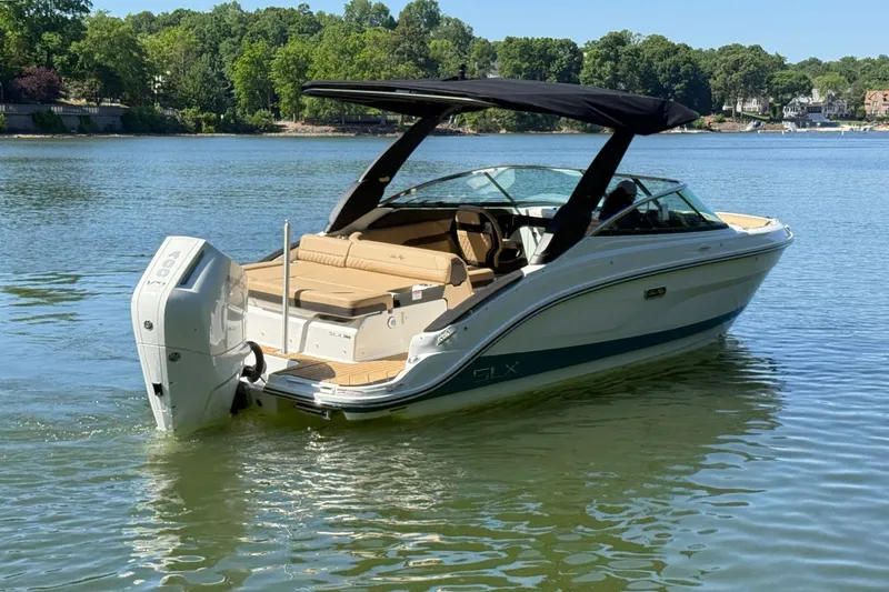 Slide: The Image of 2026 Sea Ray SLX 260 Outboard on a serene lake. - 3