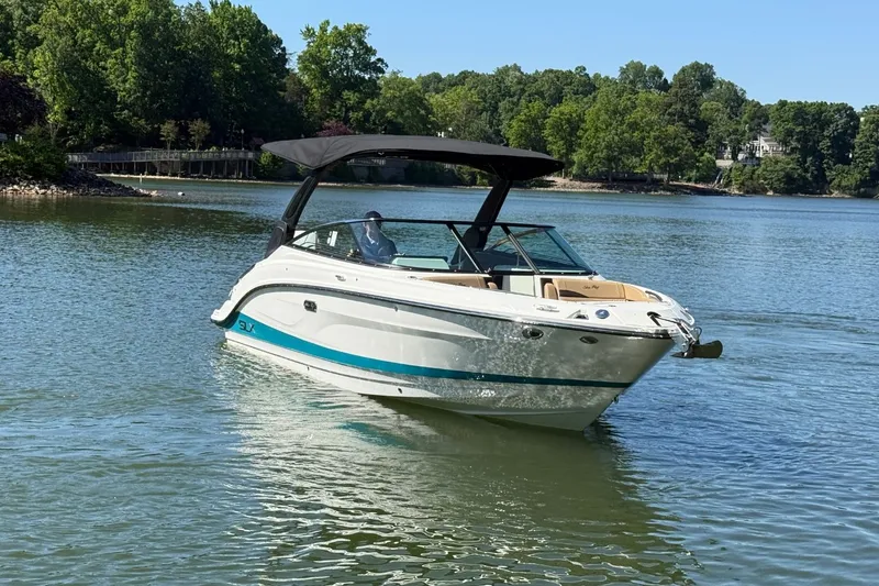 Slide: The Image of 2026 Sea Ray SLX 260 Outboard on a tranquil lake. - 5