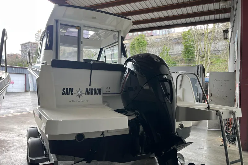 Slide: The Image of 2022 Jeanneau NC Weekender 695 Series 2 boat with outboard motor in a covered dock. - 23