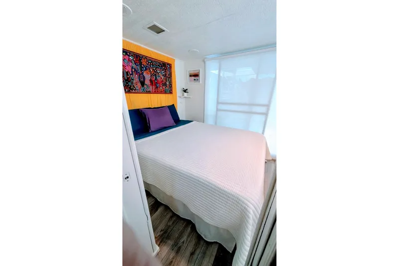 Slide: The Image of Compact bathroom in 1986 Stardust Cruisers 52, featuring shower, sink, and colorful decor. - 12