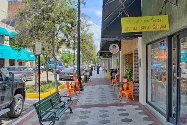 Slide: The Image of Outdoor ice cream shop with people dining, vibrant evening atmosphere. - 23