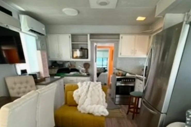 Slide: The Image of Interior of a cozy 1986 Stardust Cruisers 52 houseboat with modern decor and kitchen. - 4
