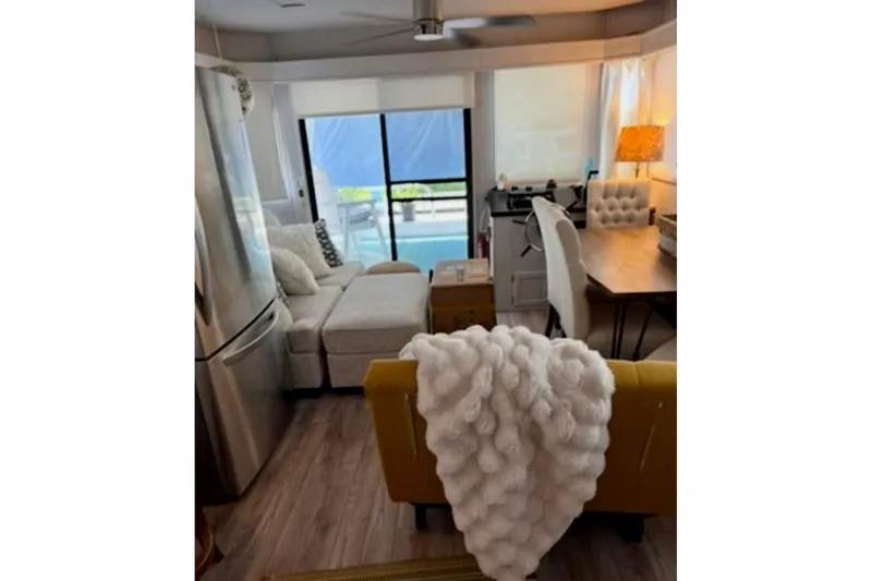 Slide: The Image of Compact kitchen in a 1986 Stardust Cruisers 52, featuring modern appliances and white cabinetry. - 6