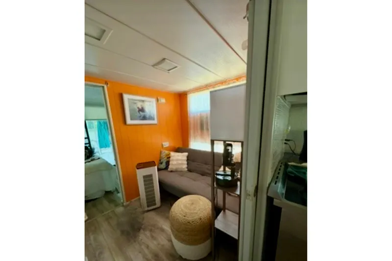 Slide: The Image of Cozy 1986 Stardust Cruisers 52 interior with vibrant decor and green curtains. - 9