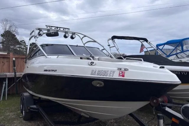 The Image of 2009 Yamaha Boats AR230 HO on trailer, parked outdoors under cloudy sky. - 0