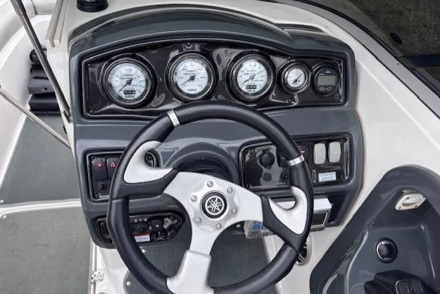 Slide: The Image of 2009 Yamaha Boats AR230 HO dashboard with steering wheel and gauges. - 10