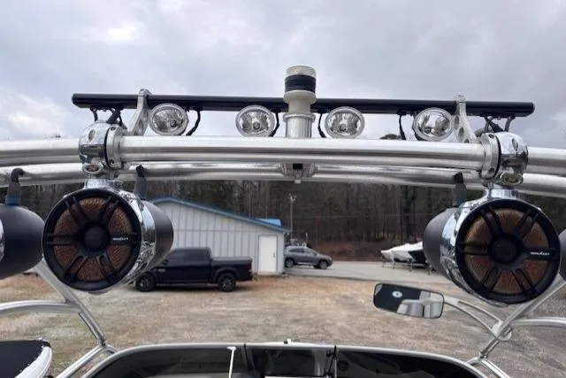 Slide: The Image of 2009 Yamaha Boats AR230 HO with mounted speakers and lights, parked outdoors. - 16