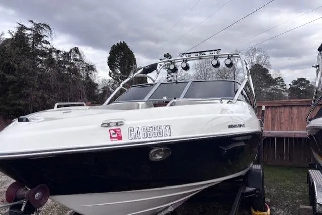 Slide: The Image of 2009 Yamaha Boats AR230 HO on trailer, parked outdoors under cloudy sky. - 2
