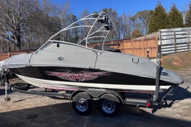 Slide: The Image of 2009 Yamaha Boats AR230 HO on trailer, covered, parked outdoors. - 3