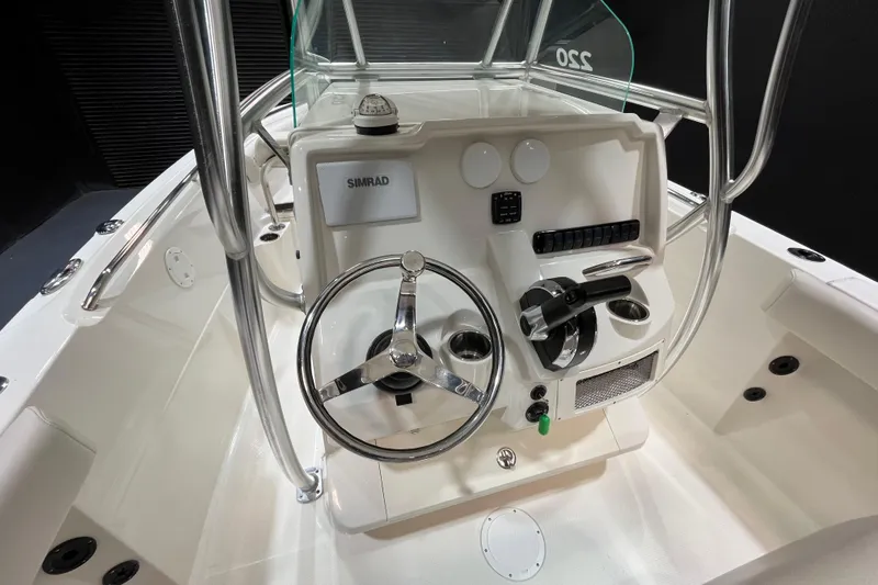 Slide: The Image of 2023 Sailfish 220 CC boat console with steering wheel and controls. - 10