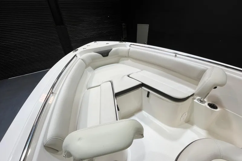 Slide: The Image of 2023 Sailfish 220 CC boat interior with white cushioned seating and sleek design. - 14