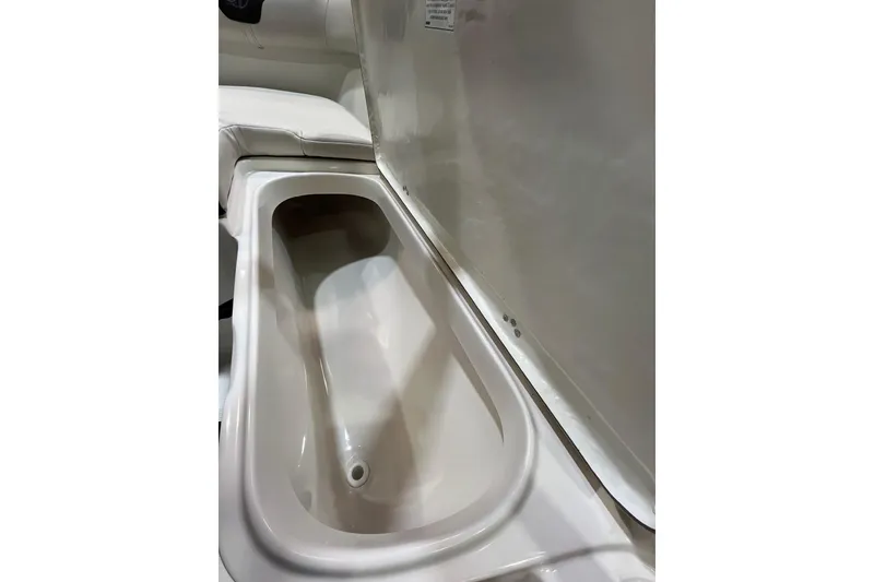 Slide: The Image of 2023 Sailfish 220 CC boat storage compartment, open and empty. - 16