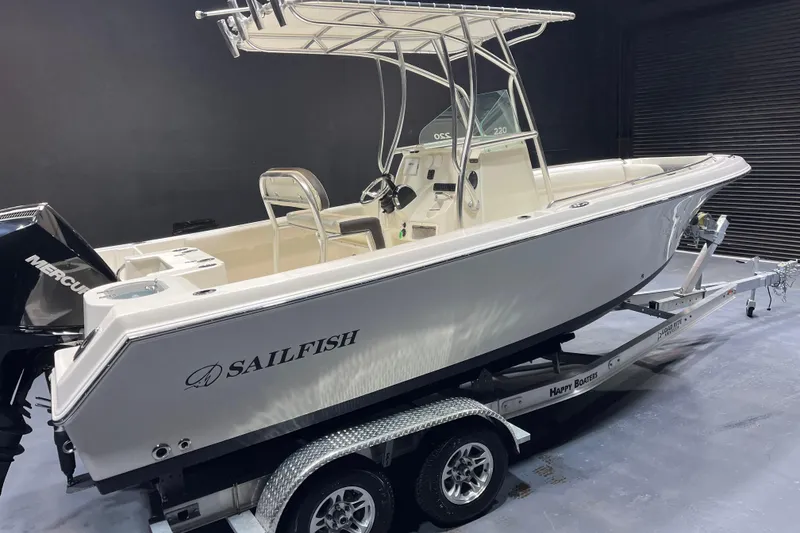 Slide: The Image of 2023 Sailfish 220 CC boat on trailer, featuring sleek design and Mercury engine. - 4
