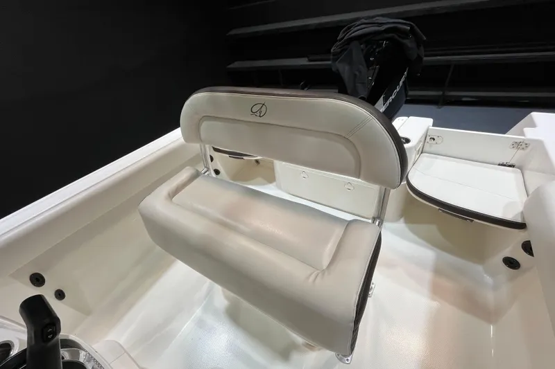 Slide: The Image of 2023 Sailfish 220 CC boat interior with cushioned seating and sleek design. - 8