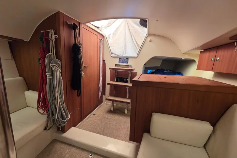 Slide: The Image of Interior of 2018 Tofinou 12 sailboat with wooden cabinetry and seating. - 12