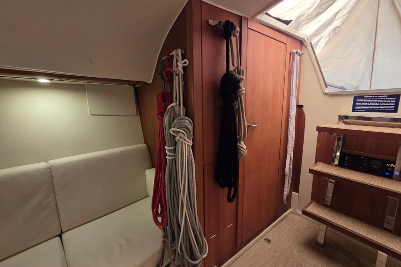 Slide: The Image of Interior of 2018 Tofinou 12 sailboat with ropes and wooden cabinetry. - 13
