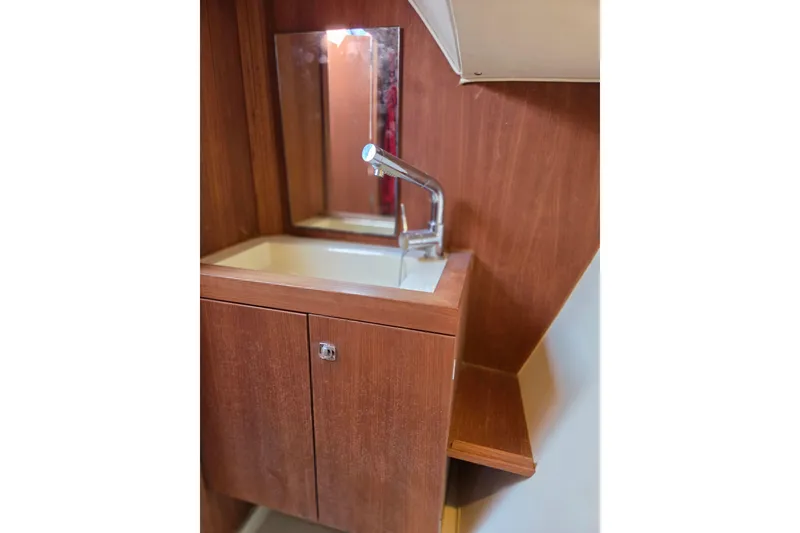 Slide: The Image of Wooden vanity with sink and mirror in 2018 Tofinou 12 yacht interior. - 18