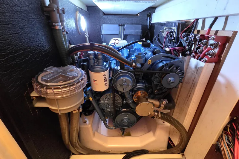 Slide: The Image of Engine compartment of a 2018 Tofinou 12 sailboat, showcasing detailed mechanical components. - 19