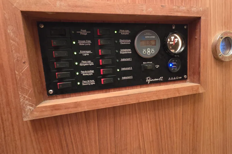Slide: The Image of Control panel of a 2018 Tofinou 12 yacht with various switches and gauges. - 22