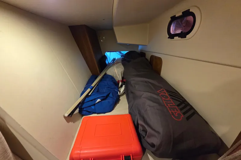 Slide: The Image of Cozy cabin interior of 2018 Tofinou 12 sailboat with storage items and porthole. - 24