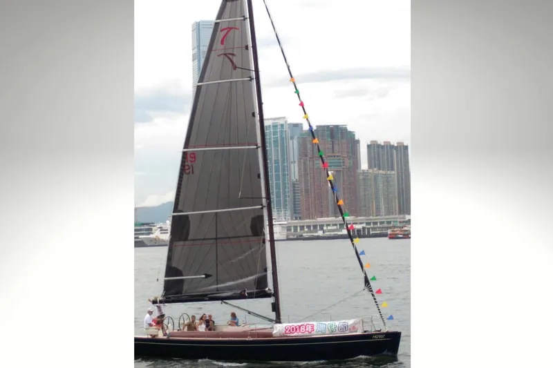 Slide: The Image of 2018 Tofinou 12 sailboat on water with city skyline in background. - 31