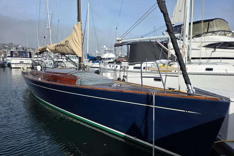 Slide: The Image of 2018 Tofinou 12 sailboat docked in a marina, featuring sleek design and blue hull. - 4