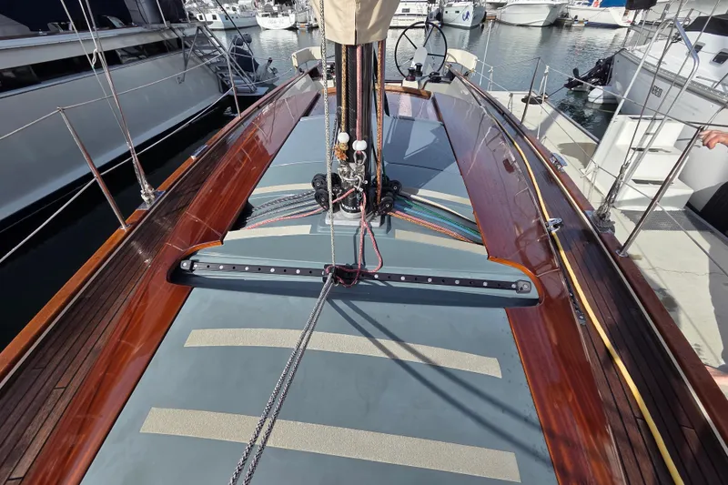 Slide: The Image of 2018 Tofinou 12 sailboat deck with sleek wood finish and modern rigging. - 6