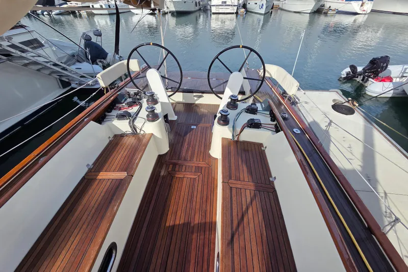 Slide: The Image of 2018 Tofinou 12 sailboat cockpit with dual steering wheels and wooden deck. - 7