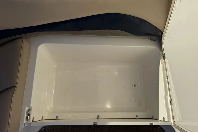 Slide: The Image of 2015 Hurricane SunDeck Sport 202 IO storage compartment, open and empty. - 12