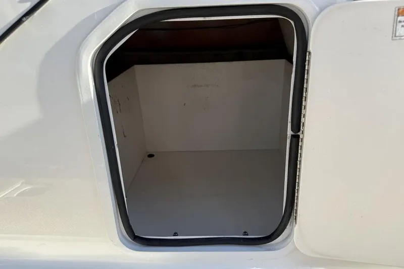 Slide: The Image of Open storage compartment on a 2015 Hurricane SunDeck Sport 202 IO boat. - 16