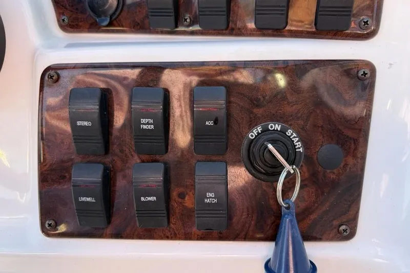 Slide: The Image of Control panel of a 2015 Hurricane SunDeck Sport 202 IO boat with switches and ignition. - 20