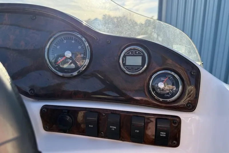 Slide: The Image of Dashboard of 2015 Hurricane SunDeck Sport 202 IO boat with gauges and controls. - 24