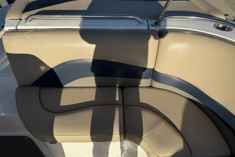 Slide: The Image of 2015 Hurricane SunDeck Sport 202 IO boat seating, beige and blue upholstery, sunny day. - 26