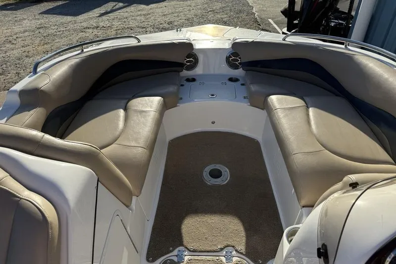 Slide: The Image of 2015 Hurricane SunDeck Sport 202 IO boat interior with beige seating and carpeted floor. - 5