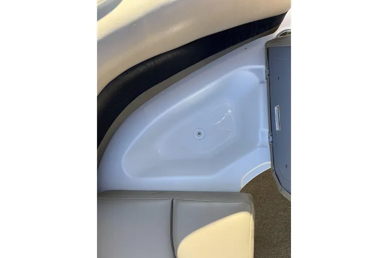 Slide: The Image of 2015 Hurricane SunDeck Sport 202 IO interior seating and storage area. - 7