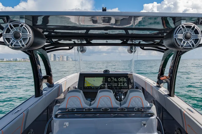 Slide: The Image of 2022 Midnight Express 37' Open boat interior with advanced navigation system on open water. - 12