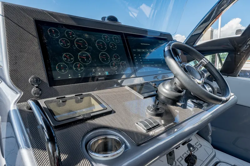 Slide: The Image of 2022 Midnight Express 37' Open boat dashboard with advanced navigation controls and touchscreen display. - 17
