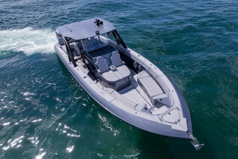 Slide: The Image of 2022 Midnight Express 37' Open boat cruising on clear blue water. - 2