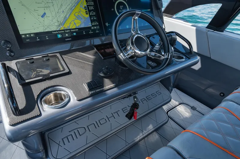 Slide: The Image of 2022 Midnight Express 37' Open boat dashboard with navigation system and steering wheel. - 20