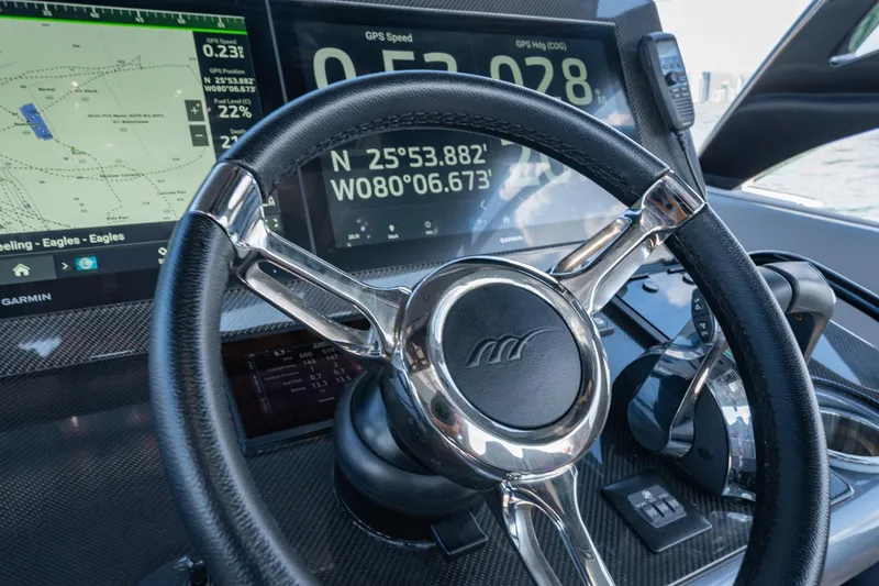 Slide: The Image of Steering wheel and dashboard of 2022 Midnight Express 37' Open boat with GPS display. - 22