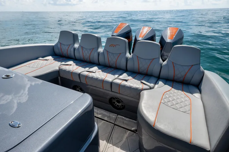 Slide: The Image of 2022 Midnight Express 37' Open boat with luxurious seating and powerful engines on open water. - 28