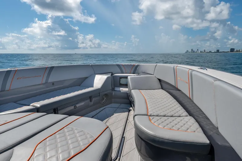 Slide: The Image of 2022 Midnight Express 37' Open boat interior with ocean view, luxury seating, and clear skies. - 37