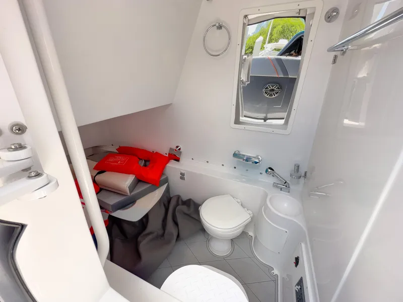 Slide: The Image of 2022 Midnight Express 37' Open boat interior bathroom with life jackets and modern amenities. - 42