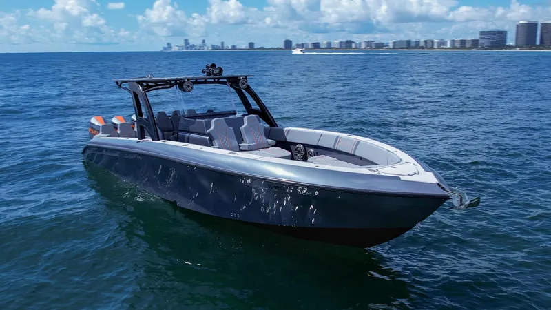 Slide: The Image of 2022 Midnight Express 37' Open boat on ocean with city skyline in background. - 5