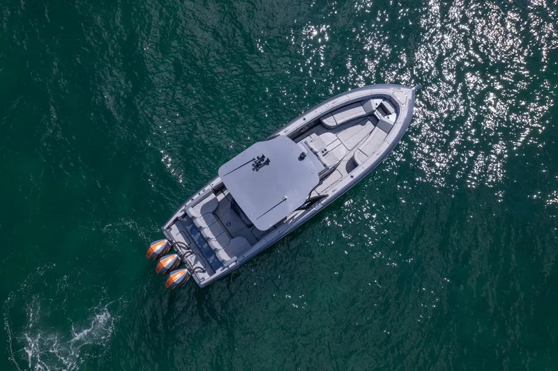 Slide: The Image of Aerial view of 2022 Midnight Express 37' Open boat on shimmering water. - 6