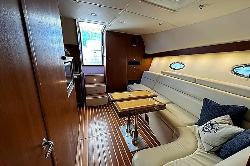 Slide: The Image of Interior of 2004 Tiara Yachts 4200 Open, featuring elegant wood and leather seating. - 16