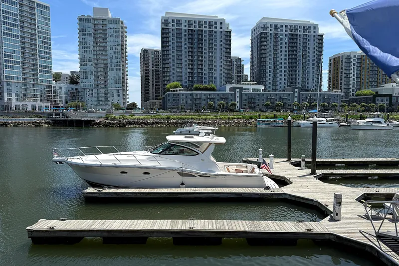 Slide: The Image of 2004 Tiara Yachts 4200 Open docked in urban marina with skyscrapers. - 17